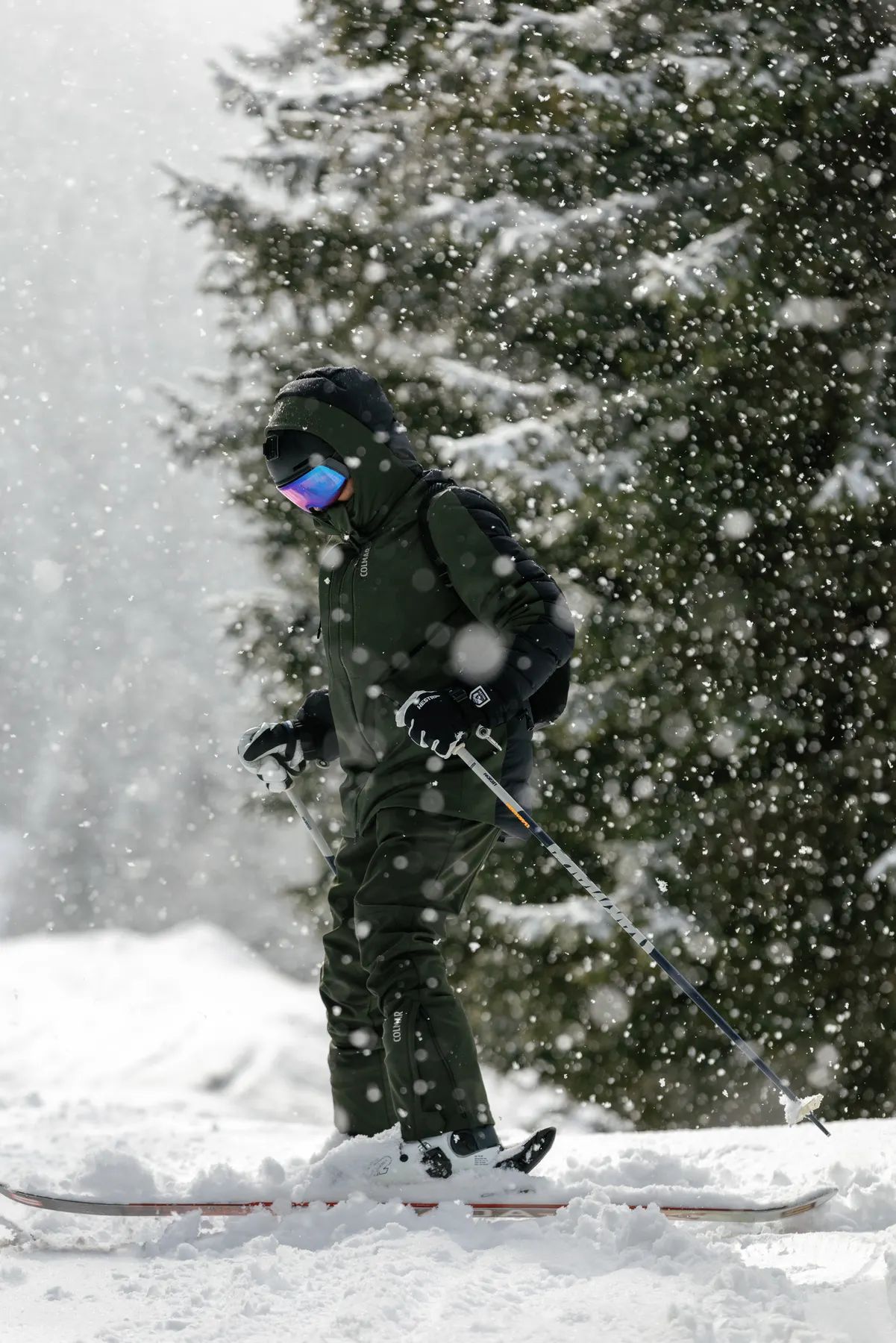 Skier wearing Colmar ski wear skiing through heavy snowfall in Courchevel.